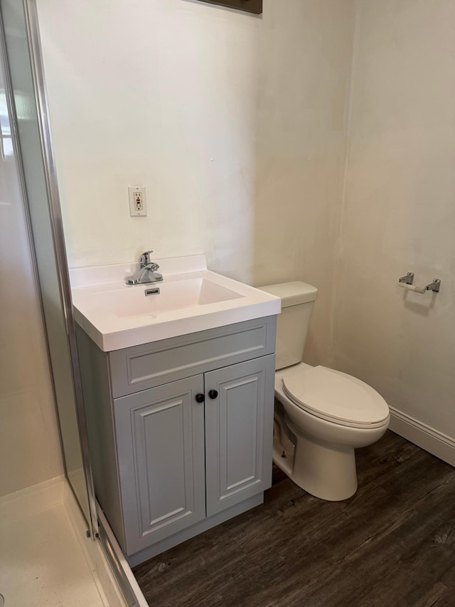 608 Duluth Ave N, Thief River Falls, MN 56701 - bathroom featuring wood finished floors, vanity, and a shower