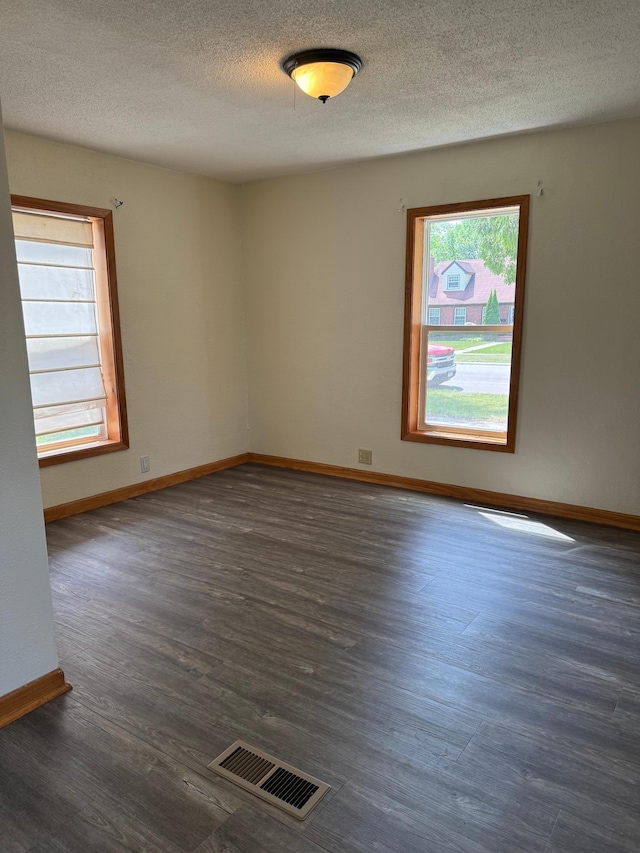 608 Duluth Ave N, Thief River Falls, MN 56701 - spare room featuring a textured ceiling and dark wood-style floors