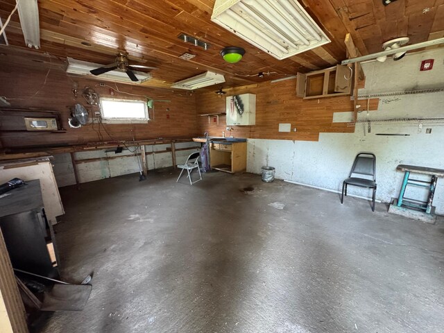 608 Duluth Ave N, Thief River Falls, MN 56701 - garage featuring a workshop area, ceiling fan, and wooden walls