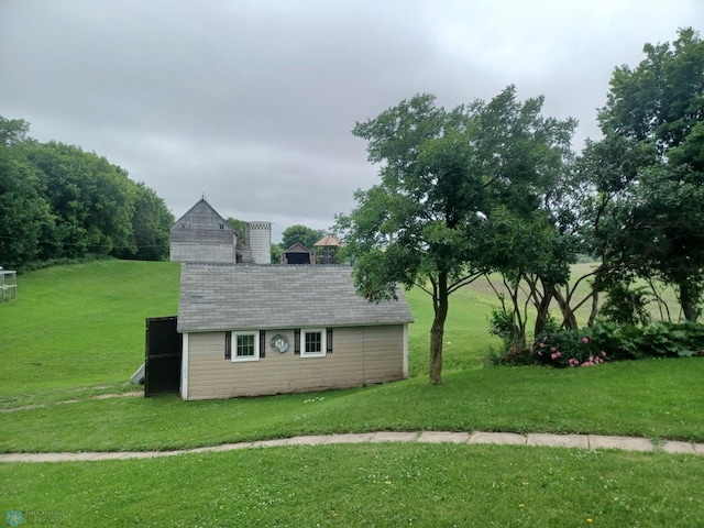 72558 209th St, Collinwood Twp, MN 55325 - view of home's exterior featuring an outbuilding and a lawn