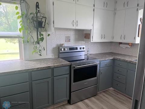 72558 209th St, Collinwood Twp, MN 55325 - kitchen with stainless steel range with electric cooktop, gray cabinets, light wood-style flooring, and decorative backsplash