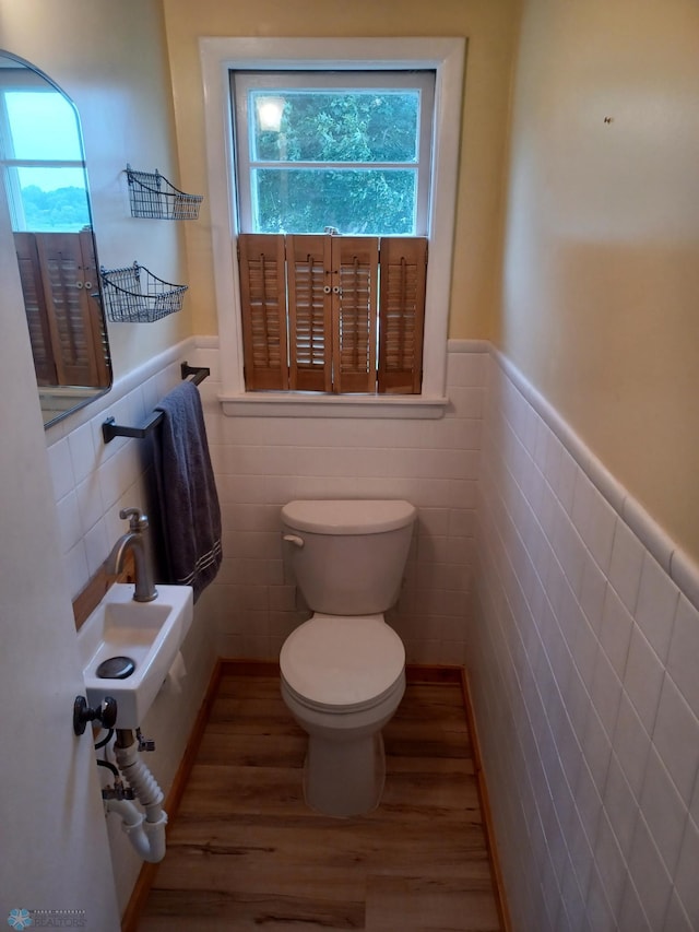 72558 209th St, Collinwood Twp, MN 55325 - half bathroom featuring wood finished floors, a wainscoted wall, and tile walls