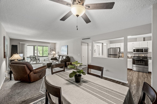 4385 Trenton Ln N Unit 309, Plymouth, MN 55442 - dining space featuring a textured ceiling, dark wood-style floors, and ceiling fan
