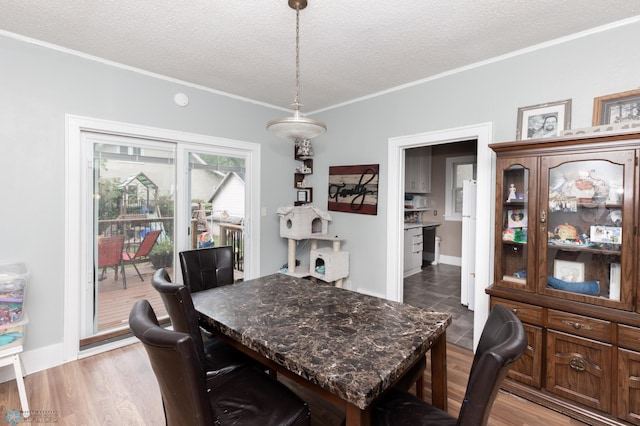 1205 11th St S, Fargo, ND 58103 - dining room featuring a textured ceiling, ornamental molding, and wood finished floors