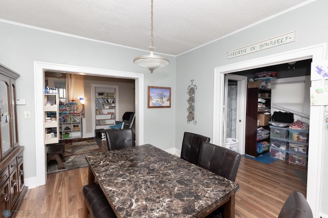 1205 11th St S, Fargo, ND 58103 - dining area featuring a textured ceiling, ornamental molding, and wood finished floors