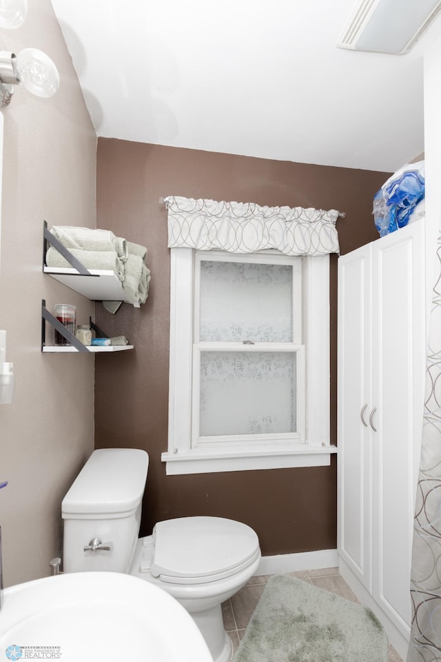 1205 11th St S, Fargo, ND 58103 - bathroom featuring toilet and tile patterned flooring