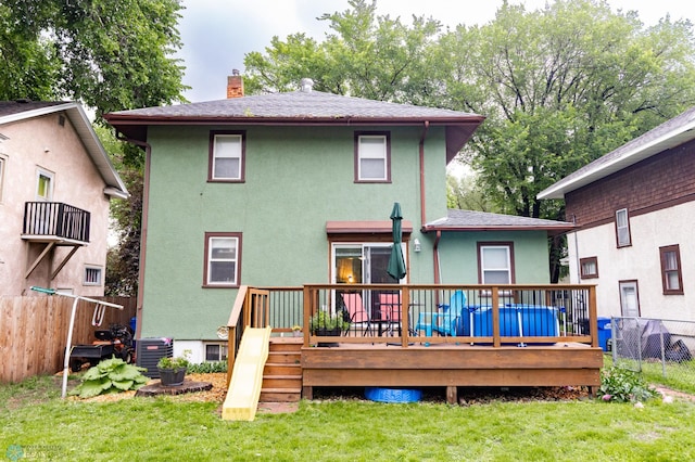 1205 11th St S, Fargo, ND 58103 - rear view of house featuring stucco siding, a chimney, and a deck