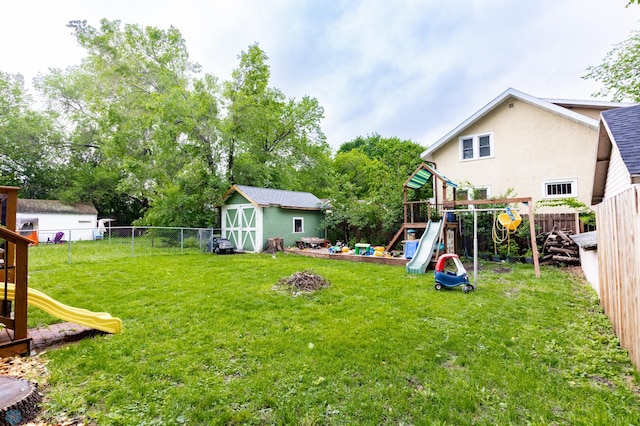 1205 11th St S, Fargo, ND 58103 - fenced backyard with a playground and a storage unit