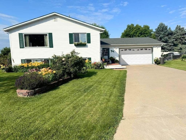 2900 16th Ave S, Moorhead, MN 56560 - split level home featuring concrete driveway, an attached garage, and a front lawn