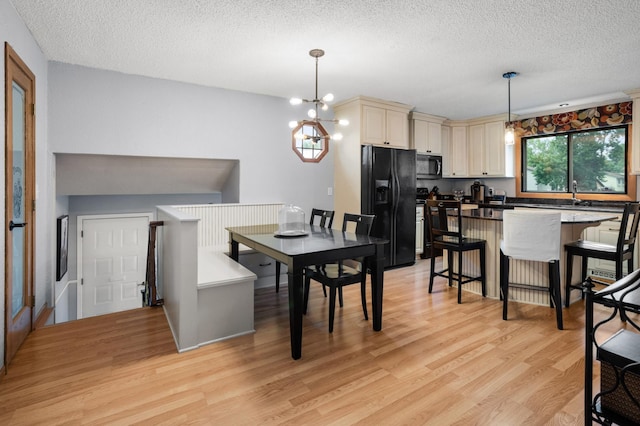 2900 16th Ave S, Moorhead, MN 56560 - dining space with a textured ceiling, light wood-style flooring, and a chandelier