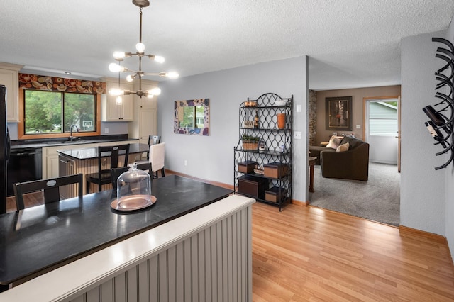 2900 16th Ave S, Moorhead, MN 56560 - dining area featuring plenty of natural light, light wood-style flooring, a chandelier, and a textured ceiling