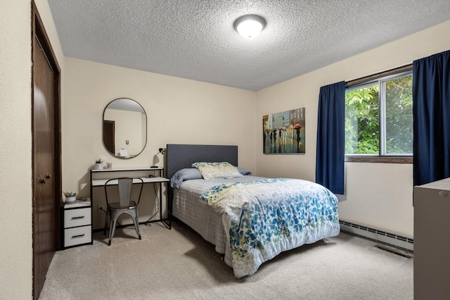 2900 16th Ave S, Moorhead, MN 56560 - bedroom featuring baseboard heating, light carpet, and a textured ceiling