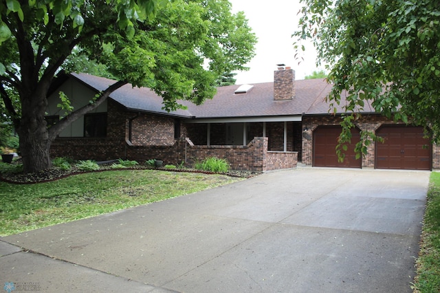 1413 4th St N, Fargo, ND 58102 - single story home with a garage, concrete driveway, brick siding, a front yard, and a shingled roof