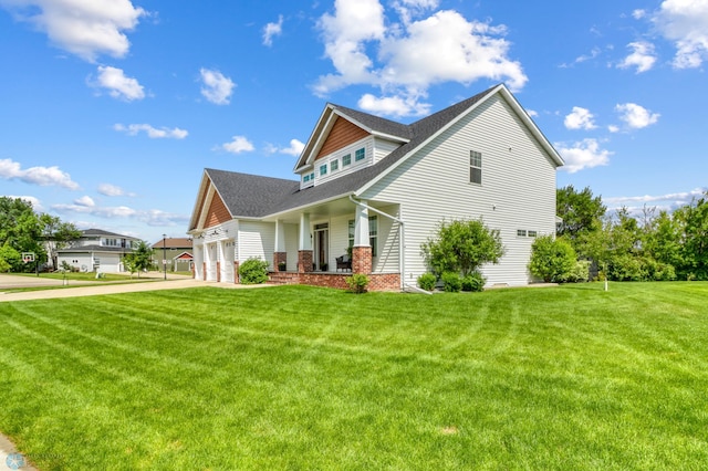 6728 Ashwood Loop, Fargo, ND 58104 - view of front of home with covered porch, a front yard, a shingled roof, driveway, and brick siding