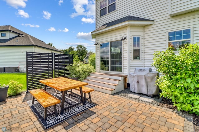 6728 Ashwood Loop, Fargo, ND 58104 - view of patio featuring area for grilling, entry steps, and outdoor dining area