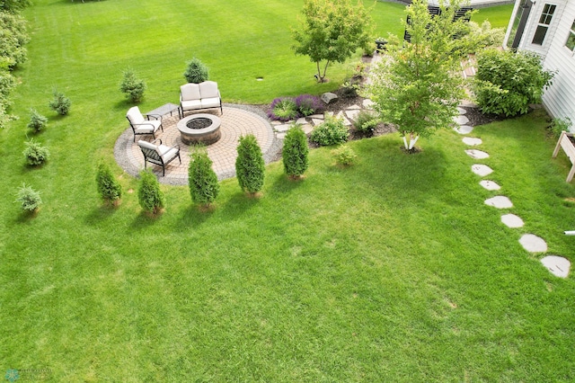 6728 Ashwood Loop, Fargo, ND 58104 - view of green lawn featuring an outdoor fire pit and a patio