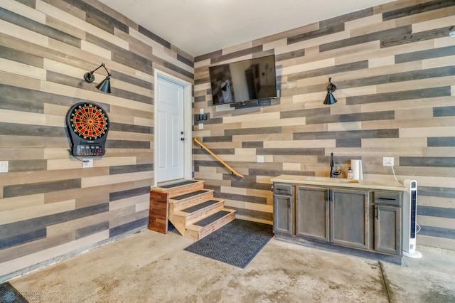 6728 Ashwood Loop, Fargo, ND 58104 - miscellaneous room featuring concrete floors and wooden walls