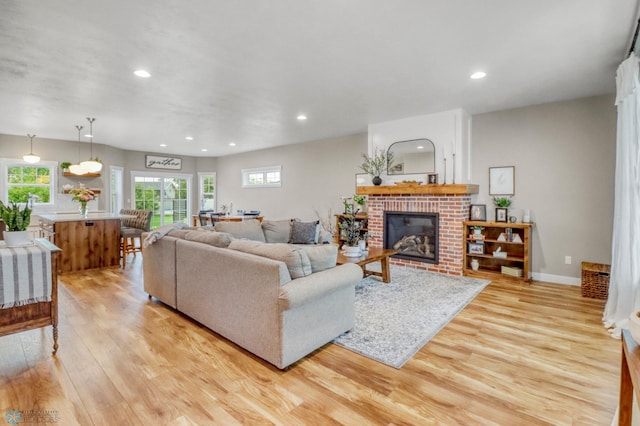 6728 Ashwood Loop, Fargo, ND 58104 - living area featuring light wood-style flooring, recessed lighting, and a fireplace