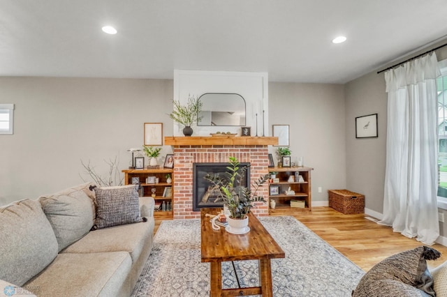 6728 Ashwood Loop, Fargo, ND 58104 - living room with wood finished floors, a brick fireplace, and recessed lighting