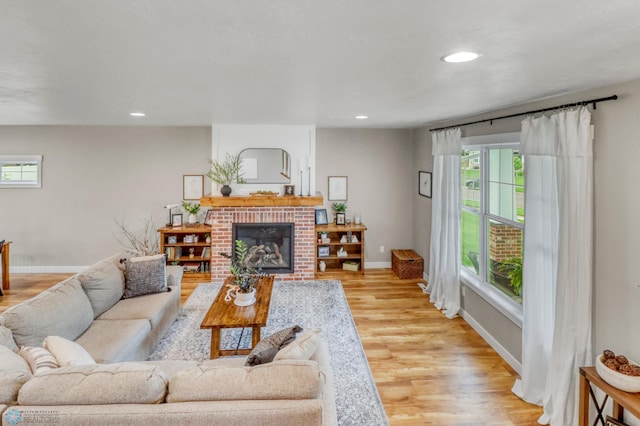 6728 Ashwood Loop, Fargo, ND 58104 - living room with a brick fireplace, light wood-type flooring, and recessed lighting