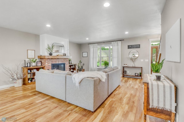 6728 Ashwood Loop, Fargo, ND 58104 - living area featuring a brick fireplace, light wood finished floors, and recessed lighting