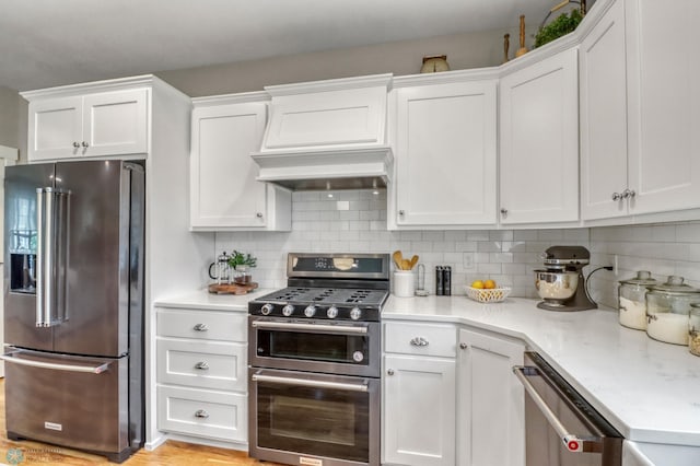 6728 Ashwood Loop, Fargo, ND 58104 - kitchen with stainless steel appliances, white cabinetry, and decorative backsplash