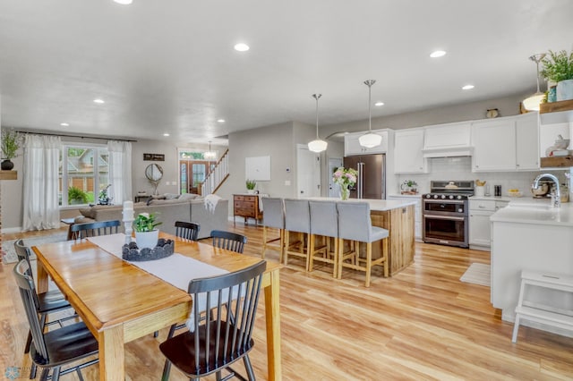 6728 Ashwood Loop, Fargo, ND 58104 - dining area featuring stairs, light wood-style flooring, and recessed lighting