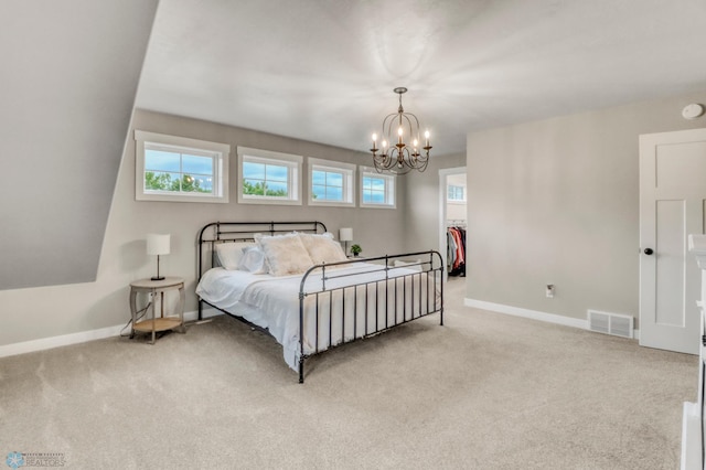 6728 Ashwood Loop, Fargo, ND 58104 - carpeted bedroom with a chandelier, a spacious closet, and a closet