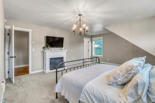 6728 Ashwood Loop, Fargo, ND 58104 - bedroom with carpet, a chandelier, and a glass covered fireplace