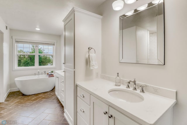 6728 Ashwood Loop, Fargo, ND 58104 - bathroom with vanity and a soaking tub