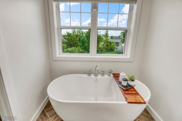 6728 Ashwood Loop, Fargo, ND 58104 - bathroom featuring a soaking tub and tile patterned flooring