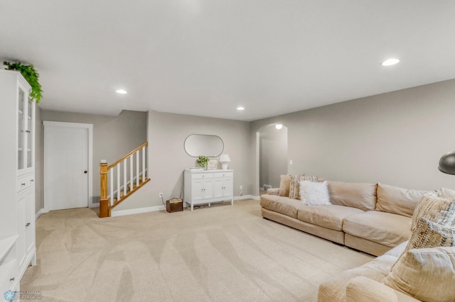 6728 Ashwood Loop, Fargo, ND 58104 - living area with arched walkways, light carpet, stairs, and recessed lighting