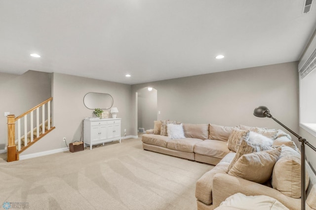 6728 Ashwood Loop, Fargo, ND 58104 - living room with arched walkways, recessed lighting, carpet flooring, and stairs