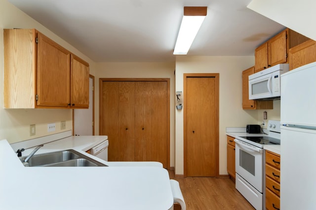 8454 Copperfield Way Unit 75, Inver Grove Heights, MN 55076 - kitchen featuring white appliances, light wood-style floors, light countertops, and a peninsula