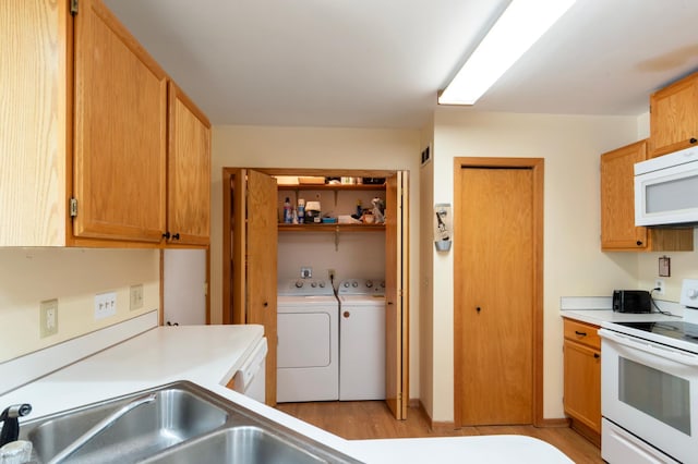 8454 Copperfield Way Unit 75, Inver Grove Heights, MN 55076 - kitchen with white appliances, washing machine and dryer, light wood-type flooring, and light countertops