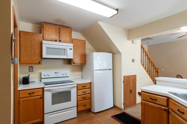 8454 Copperfield Way Unit 75, Inver Grove Heights, MN 55076 - kitchen with white appliances, light wood-type flooring, light countertops, vaulted ceiling, and brown cabinets