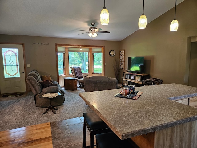 611 3rd St SW, Richville, MN 56576 - kitchen featuring open floor plan, a ceiling fan, vaulted ceiling, a breakfast bar area, and pendant lighting