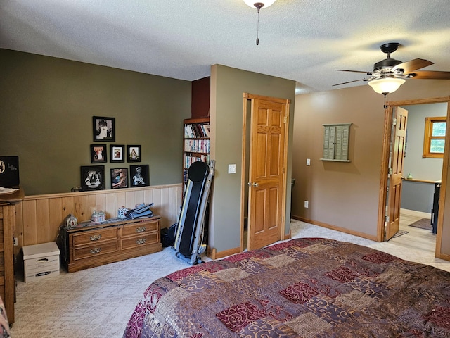 611 3rd St SW, Richville, MN 56576 - bedroom with carpet, wainscoting, a textured ceiling, a ceiling fan, and ensuite bath