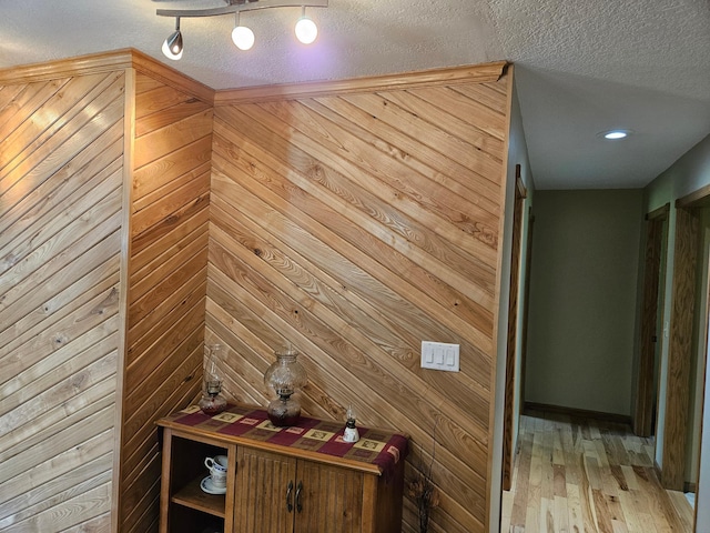 611 3rd St SW, Richville, MN 56576 - detailed view of wood walls, a textured ceiling, and wood finished floors