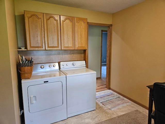 611 3rd St SW, Richville, MN 56576 - laundry area with washing machine and clothes dryer, cabinet space, and a textured ceiling
