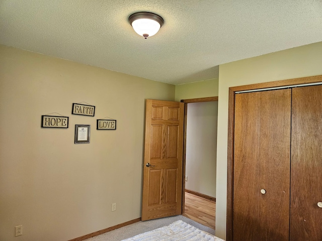 611 3rd St SW, Richville, MN 56576 - unfurnished bedroom with a closet, a textured ceiling, and light carpet