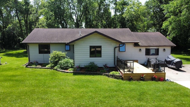 611 3rd St SW, Richville, MN 56576 - back of property featuring a lawn, a deck, and roof with shingles