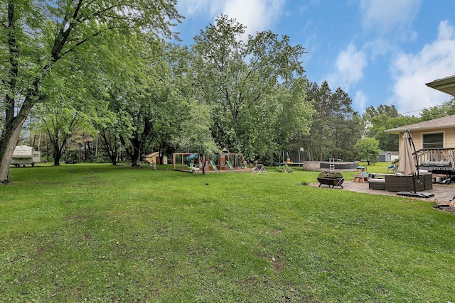 3773 County Road 74, Saint Cloud, MN 56301 - view of green lawn with an outdoor living space with a fire pit, a playground, and a patio