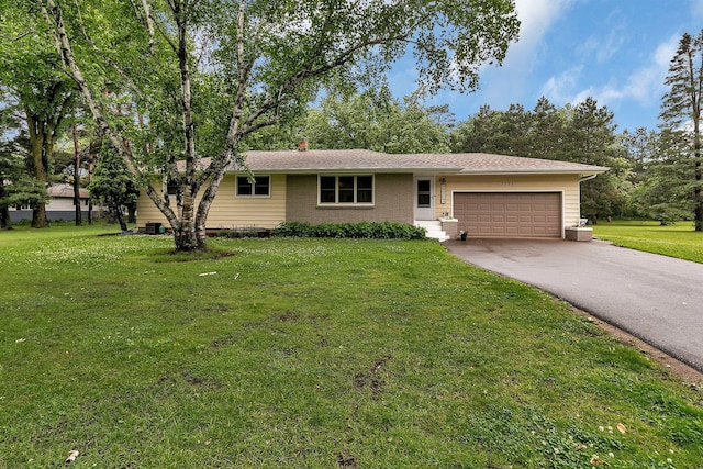 3773 County Road 74, Saint Cloud, MN 56301 - ranch-style home with asphalt driveway, an attached garage, a front lawn, and a chimney