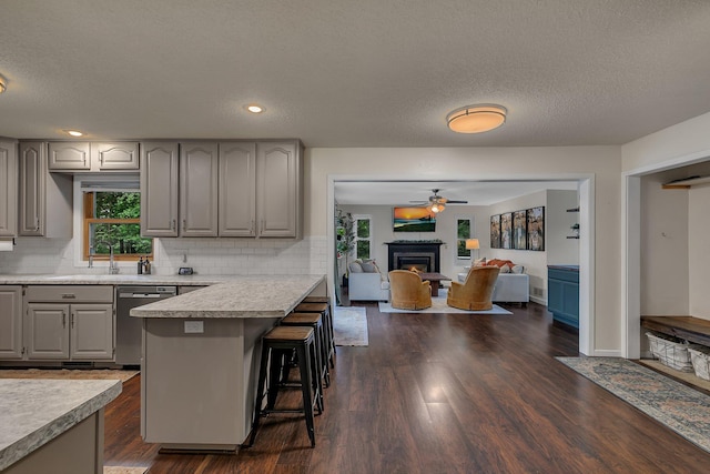 3773 County Road 74, Saint Cloud, MN 56301 - kitchen featuring gray cabinets, a breakfast bar area, tasteful backsplash, a ceiling fan, and a textured ceiling