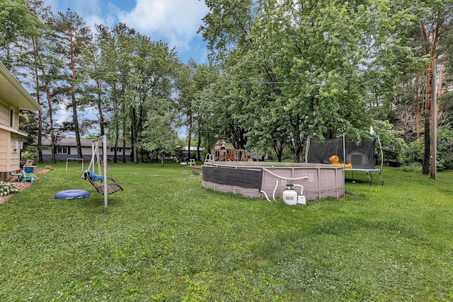 3773 County Road 74, Saint Cloud, MN 56301 - view of green lawn featuring a trampoline and view of wooded area