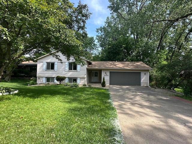2360 3rd St NW, New Brighton, MN 55112 - tri-level home with concrete driveway, a front lawn, and a garage