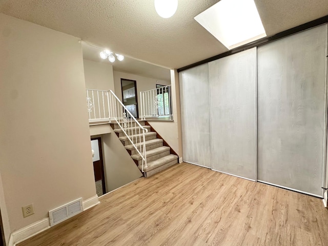 2360 3rd St NW, New Brighton, MN 55112 - basement featuring wood finished floors, stairs, and a textured ceiling