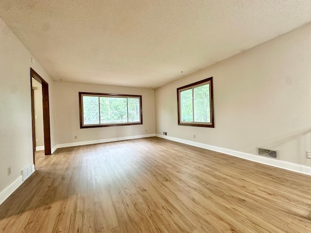 2360 3rd St NW, New Brighton, MN 55112 - empty room featuring a textured ceiling and wood finished floors