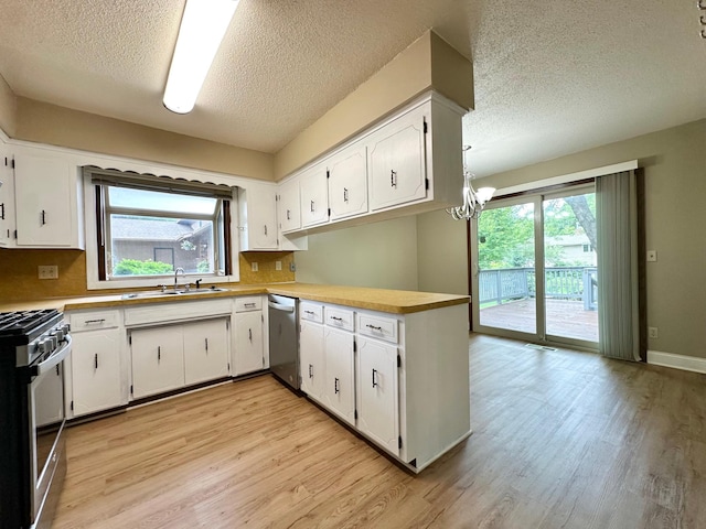 2360 3rd St NW, New Brighton, MN 55112 - kitchen featuring appliances with stainless steel finishes, a textured ceiling, a peninsula, light wood finished floors, and plenty of natural light